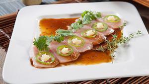 Garlic Hamachi Sashimi · Yellowtail topped with spicy yuzu ponzu sauce, garlic paste, jalapeno, and cilantro.