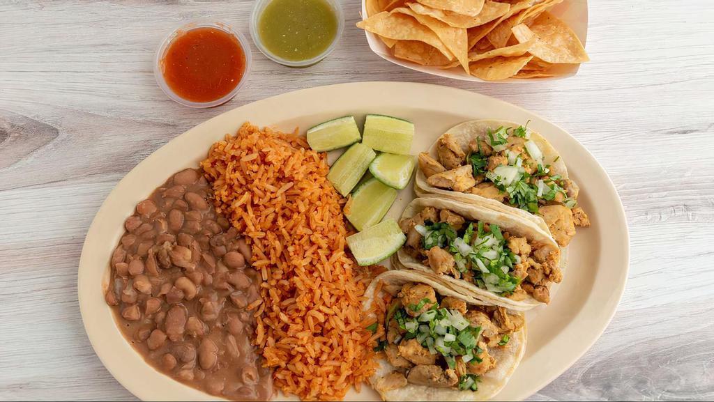 Taco Plate · Three tacos with your choice of one protein (steak, chicken, carnitas, al pastor or grilled veggies) limes, cilantro, onions. Served with rice, beans, chips, salsa, guacamole.