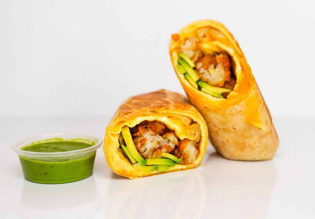 Avocado, Egg & Cheddar Breakfast Burrito · 3 fresh cracked, cage-free scrambled eggs, melted Cheddar cheese, avocado salsa verde, fresh avocado, and crispy potato tots wrapped in a toasted 12” flour tortilla. Comes with avocado salsa verde side.