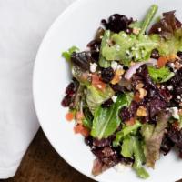 Mixed Greens · Red onions, tomatoes, blue cheese crumbles, candied walnuts, dried cranberries, and balsamic...