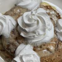 Cinnamon Roll Pancakes · Cinnamon swirl topped with a sweet icing, powdered sugar, and whipped cream.
