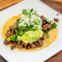 Mini Taco De Asada · Handmade tortilla street taco, meat, guacamole, onion & cilantro