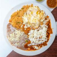Chilaquiles · Cripsy fried tortilla pieces cooked in red salsa and topped with cheese.