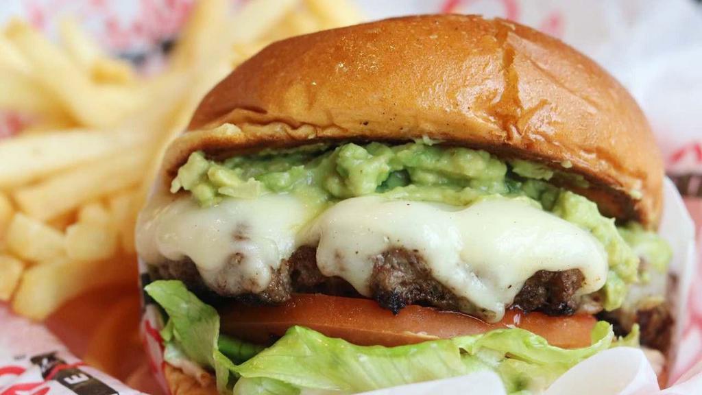 Guacamole Burger · Topped with a generous portion of housemade guacamole, two slices of Swiss cheese, crisp lettuce, tomato, and RubySauce.