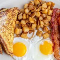 Lumberjack Breakfast · Buttery brioche French toast dusted with powdered sugar and served with a generous amount of...