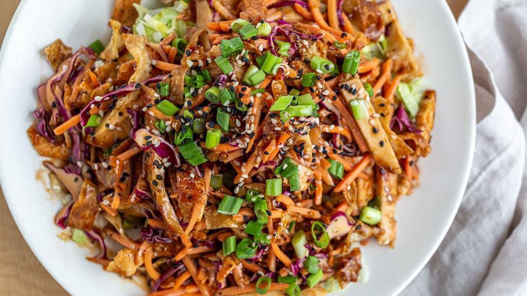 Spicy Asian Chicken Salad · Diced chicken breast, crispy wontons, carrots and red cabbage tossed in our signature Asian dressing and placed over a bed of fresh lettuce. Topped with toasted sesame seeds and green onions..