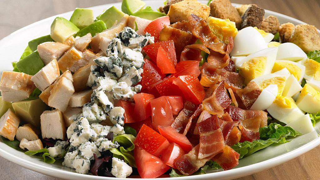 Chicken Cobb Salad · Diced chicken breast or crispy chicken tender, Applewood-smoked bacon, fresh avocado, tomatoes, chopped hard-boiled egg*, shredded cheddar cheese and croutons on romaine with creamy ranch dressing.