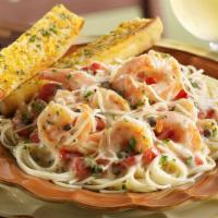 Shrimp Scampi Pasta · Tender shrimp sautéed in a garlic-butter sauce with fresh tomatoes. Served over pasta with P...