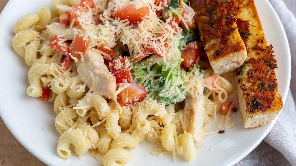 Chicken Alfredo Pasta · Chicken breast, fresh broccoli, tomatoes and pasta tossed in a creamy Alfredo sauce with Parmesan cheese and basil. Served with toasted bread.