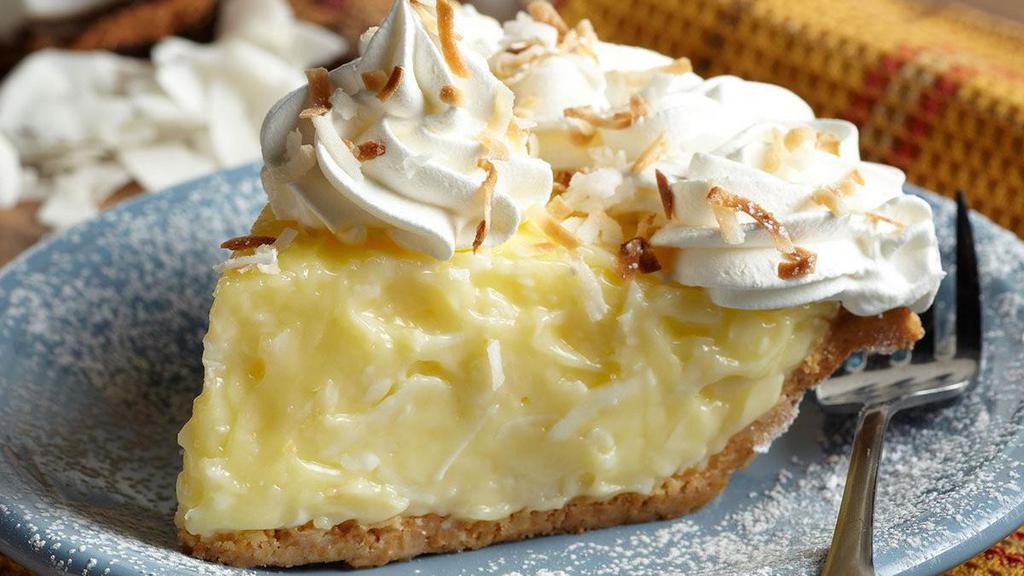 Whole Coconut Cream Pie · Fluffy coconut cream filling topped with whipped cream and sprinkled with toasted coconut.