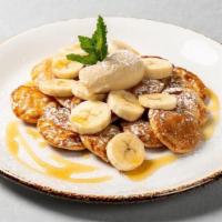 Organic Dutch Mini-Pancakes · Mini pancakes with banana, maple syrup butter and powdered sugar