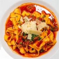 Pappardelle Alla Bolognese · Traditional slow cooked Italian tomato-meat sauce.