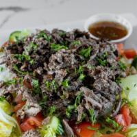 Beef Shawarma Salad · Chopped lettuce, tomatoes, onions topped with marinated beef shawarma and creamy house dress...