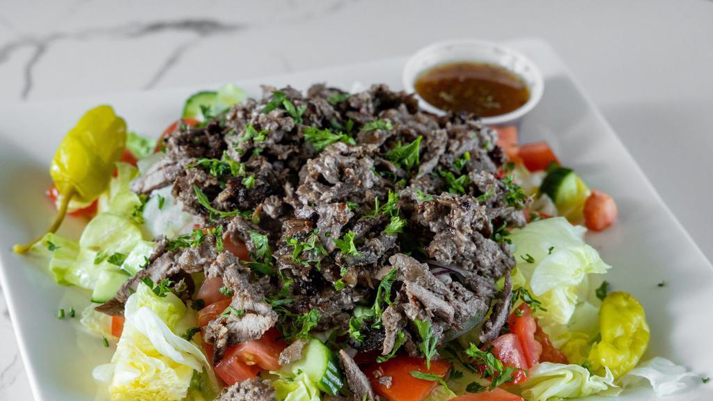 Beef Shawarma Salad · Chopped lettuce, tomatoes, onions topped with marinated beef shawarma and creamy house dressing.