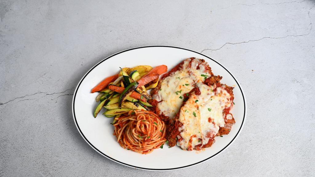 Chicken Parmigiana · Breaded chicken breast, topped with our housemade marinara sauce, Parmesan and mozzarella cheese with vegetables and spaghetti marinara.