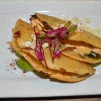Isla Cortez Shrimp Tacos · 2 crispy tacos filled with grilled shrimp, melted queso fundido, spicy aioli, roasted poblan...