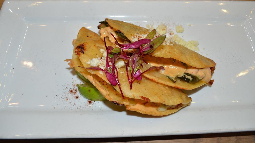 Isla Cortez Shrimp Tacos · 2 crispy tacos filled with grilled shrimp, melted queso fundido, spicy aioli, roasted poblano, serrano chile, scallion.