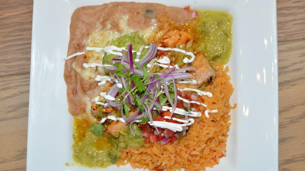 Baja Asada Bowl · Your choice of meat with fresh guacamole, cilantro, red onion, avocado tomatillo salsa, chipotle mojo, Mexican queso blend, Spanish rice,  refritos blanco,  pico, and crema.