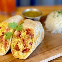 Baja Breakfast Burrito · Crispy Applewood bacon or crumbled chorizo stuffed with butter browned tater tots, queso bla...