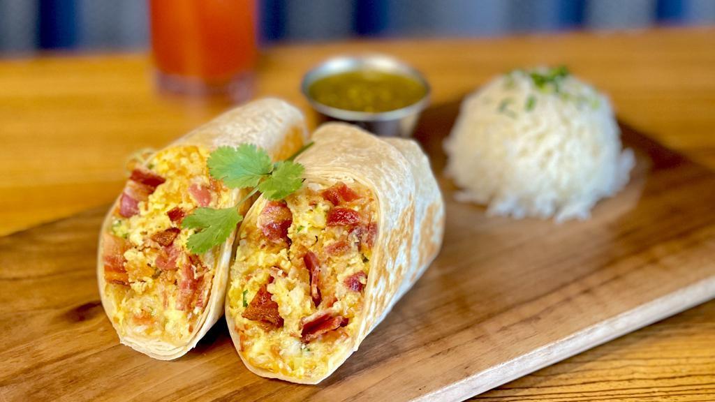 Baja Breakfast Burrito · Crispy Applewood bacon or crumbled chorizo stuffed with butter browned tater tots, queso blanco and green onion. Served with Spanish rice and roasted tomatillo salsa.