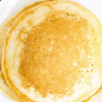 Buttermilk Pancakes · A fluffy trio stacked with butter.