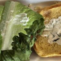 Greek Burger · A 50/50 lamb and beef patty patty on a brioche bun topped with homemade tzatziki, romaine le...
