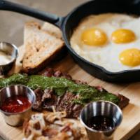 Steak N Eggs · 6 ounces skirt steak with cilantro chimichurri sauce. Served with bacon hash browns, three e...