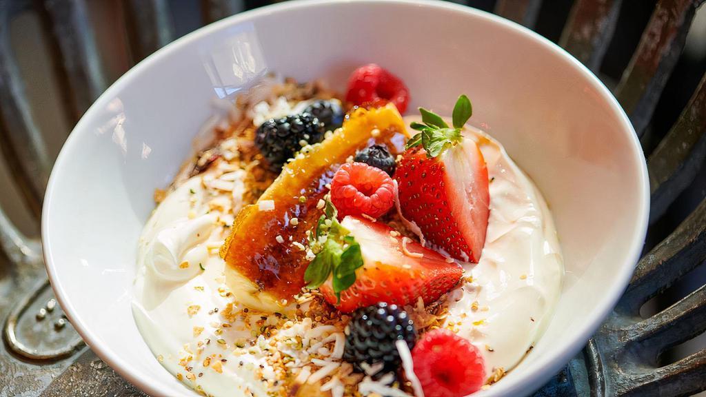 Yogurt Bowl · Contains nuts. Greek yogurt, house granola, bruleed banana, berries, chia, and coconut flakes.