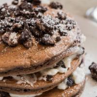 Oreo Cookie · Chocolate pancakes with cream filling and Oreo cookie crumble, topped with powdered sugar.