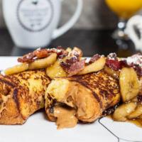 Presley · Peanut butter stuffed French toast topped with bananas foster, bacon and powdered sugar.
Con...