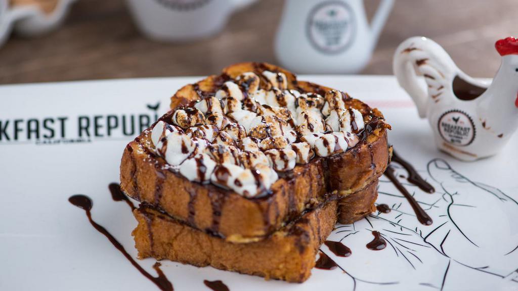 S'Mores · Vegetarian. Graham cracker crusted brioche bread topped with toasted marshmallows and chocolate sauce.