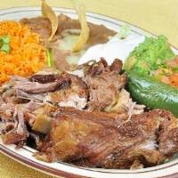 Plato De Carnitas · pork carnitas served with rice, beans, lettuce, guacamole, pico de gallo, sour cream, & tort...
