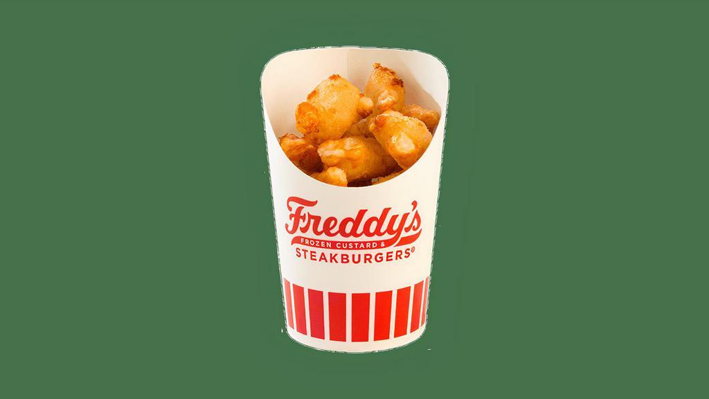 Cheese Curds · Premium white cheddar cheese curds lightly covered with butter crumbs and fried to a gooey golden perfection.