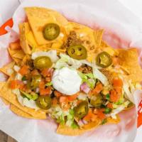 Nachos · refried beans, guacamole, cheese, salsa, sour cream. Add your choice of meat for an addition...