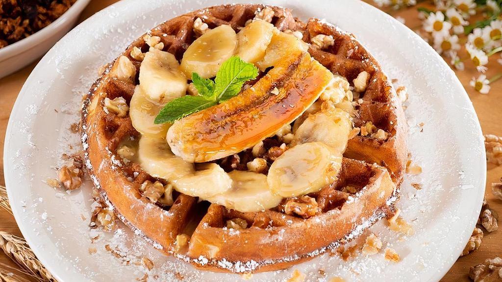 Banana Walnut Waffle · Our classic Belgian waffle with fresh bananas and caramel sauce topped with a bruleed banana and garnished with chopped roasted walnuts.