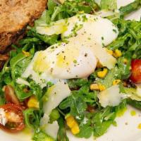 Eggs Verde · Two poached eggs over a bed of wild arugula, roasted corn,
baby tomatoes and poached asparag...
