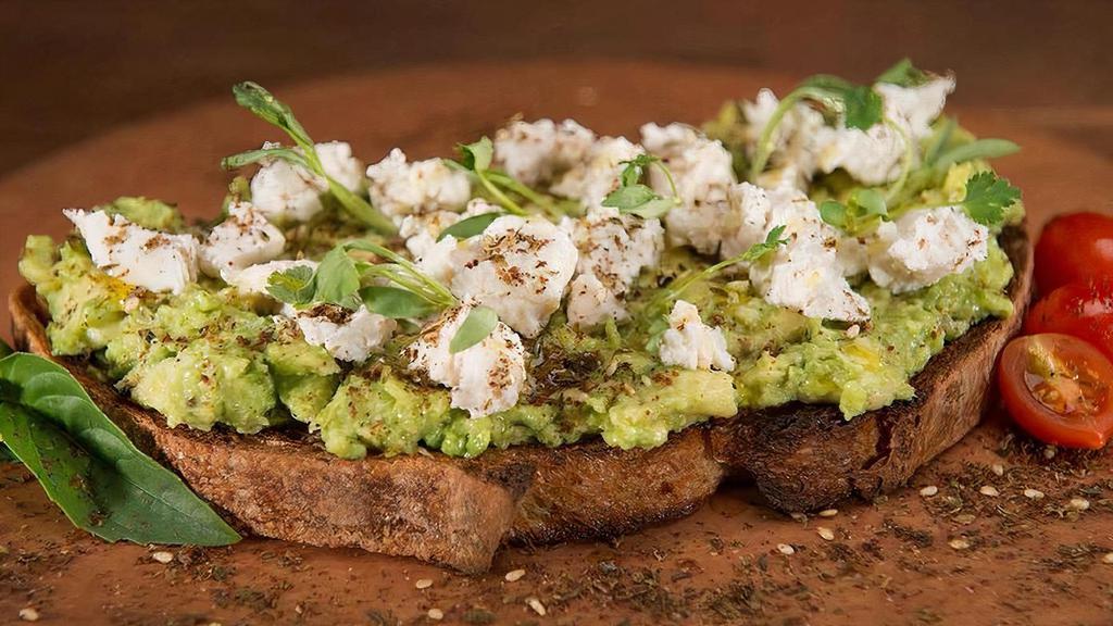 Avocado Toast · Our sprouted ancient grain bread toasted and topped with ripe 
Hass avocados, almond cheese, micro cilantro and olive oil.