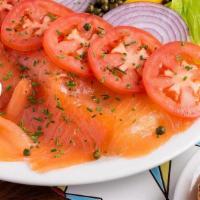Smoked Salmon Plate · Our Fresh 100% natural salmon is locally smoked, it is served with a bagel, cream cheese, Ro...