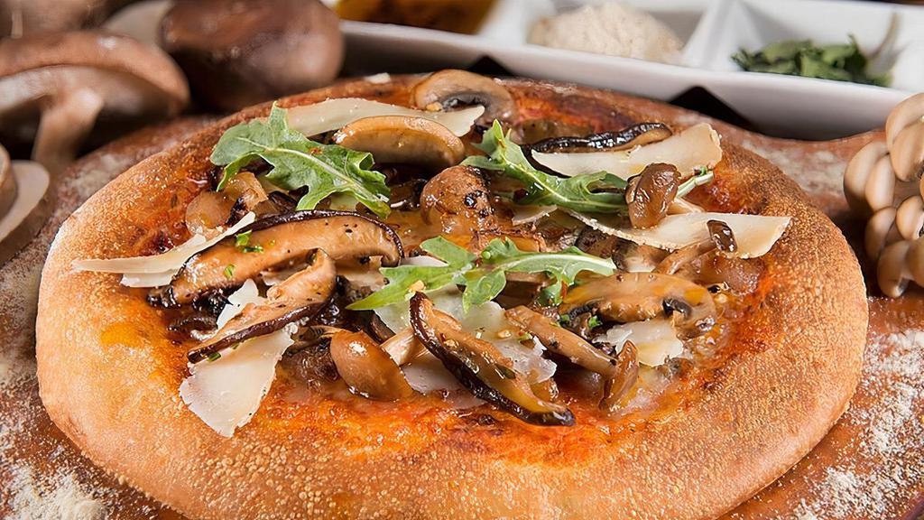 Wild Mushroom Pizza · Sauteed wild mushrooms, braised balsamic onions, mozzarella, burrata, and truffle pecorino cheeses. Garnished with wild arugula.