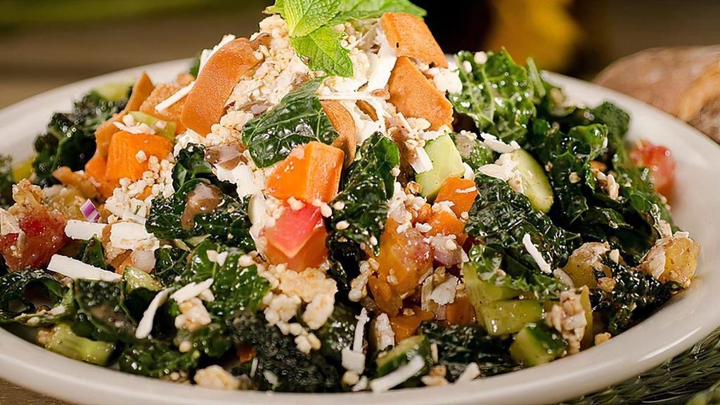 Caravan Kale Salad · Our local certified organically grown kale served with shaved ricotta, pita chips, Persian cucumbers, heirloom tomatoes, sweet potato, and mint in a pomegranate vinaigrette.
