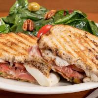 Parma Panini · Prosciutto di Parma, fresh mozzarella cheese, roasted peppers, Roma tomatoes, basil pesto, b...