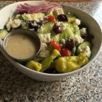Greek · Romaine hearts, mixed greens, cucumbers, olives, onions, tomatoes, pepperoncinis, and feta w...