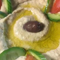 Spicy Hummus · Our famous traditional hummus mixed with our homemade hot sauce. 
Served with warm pita or s...