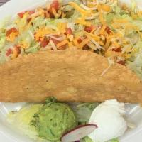 King Taco · A large crisp flour tortilla shell filled with beans, lettuce, tomatoes and cheese topped wi...