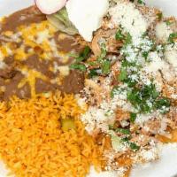 Chilaquiles · Corn tortilla chips simmered in your choice of a mild red sauce or spicy green sauce topped ...