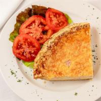 Quiche Lorraine · A slice of our famous Quiche Lorraine, smoked ham& Swiss cheese