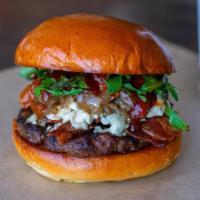 Big Blue Burger · Blue cheese, grilled onions, bacon, roasted tomato, arugula, and barbecue sauce.
