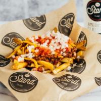 Chili Cheese Fries · Stand Fries topped with Stand beef chili, cheese, tomato, and onion.