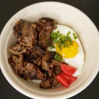 Tapsilog · Marinated thinly sliced Angus beef, garlic rice, fried egg, and pickled red radish.