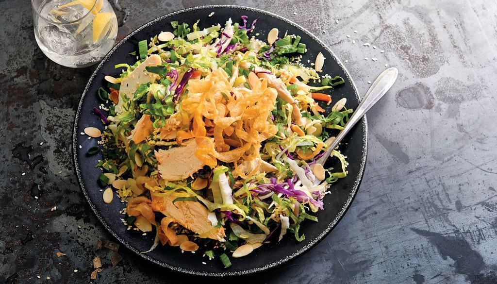 Asian Grilled Chicken Salad · Grilled chicken with crunchy noodles, almonds, sesame seeds, green onions, carrots and cilantro, tossed with sweet and spicy peanut dressing